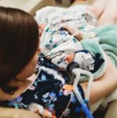 Raiven Adams Holds Newborn River Anthony