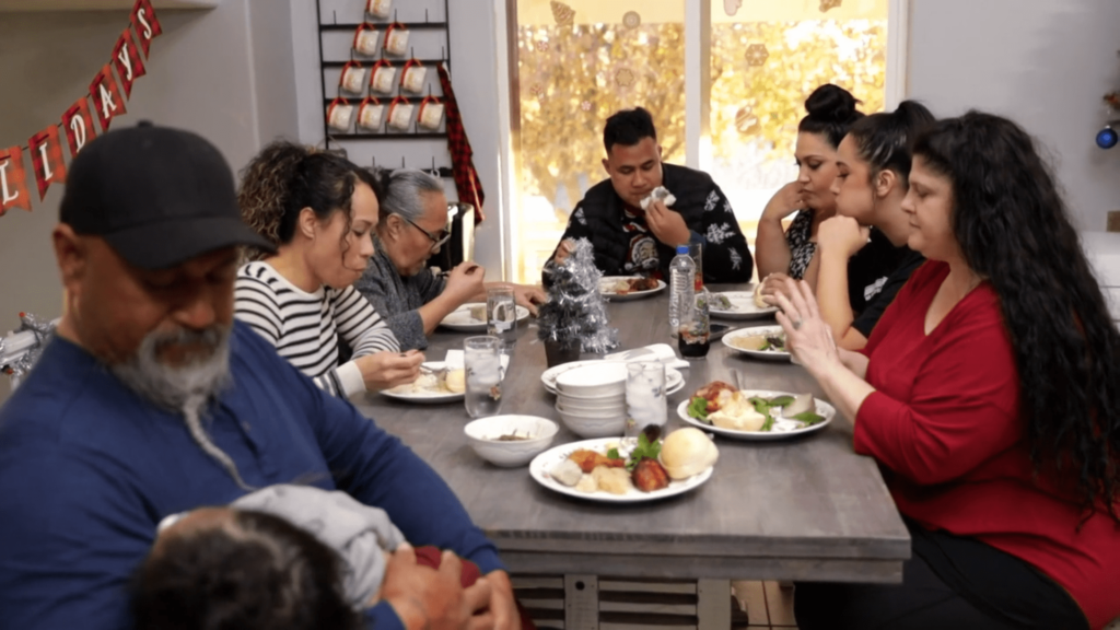 Kalani Faagata and Asuelu Pulaa eat with their families