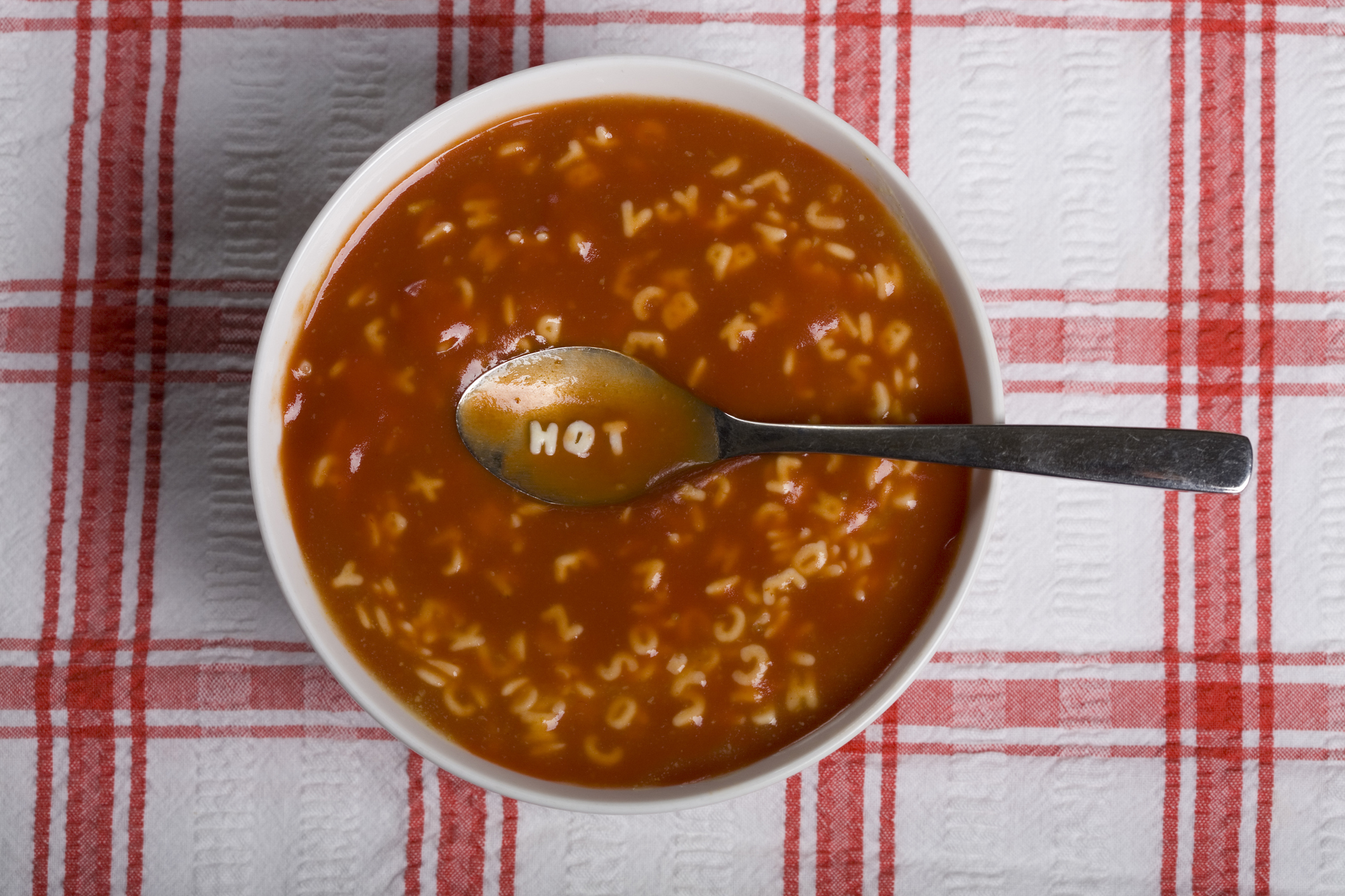 Alphabet soup with the word hot spelt out on the spoon