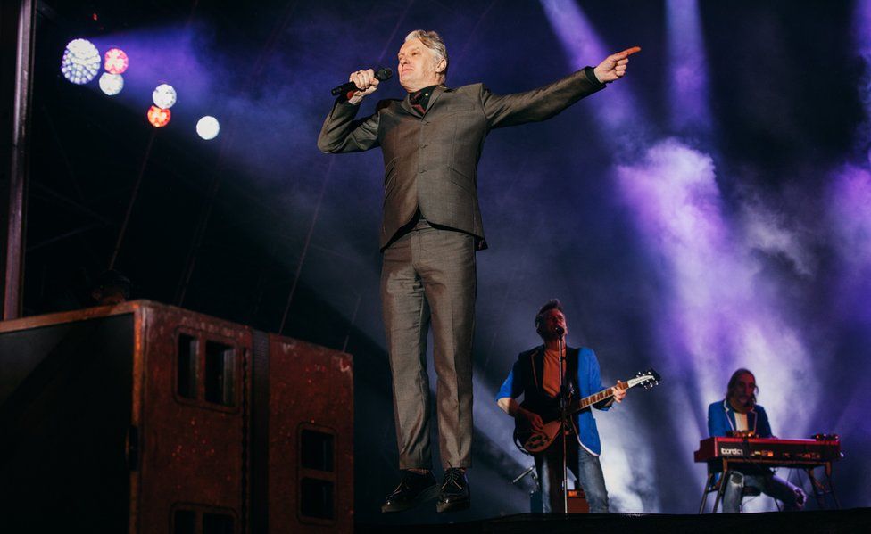 Chumbawamba frontman Dunstan Bruce with Hope and Social on stage at Leeds 2023 opening ceremony