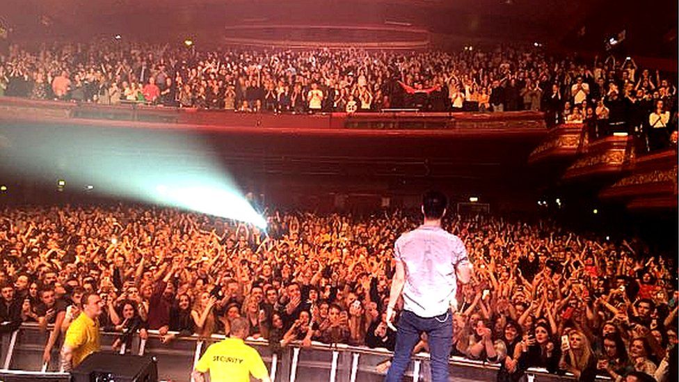 Liam Fray looking out to the audience at their third Manchester Apollo gig