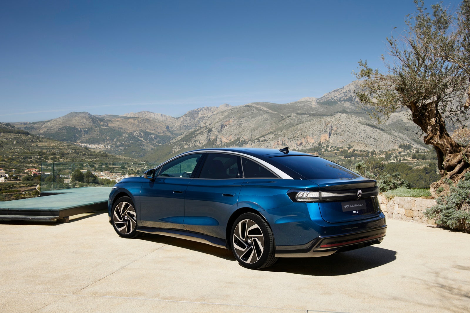 Volkswagen ID.7 EV parked outside with mountains and desert scenery in the back