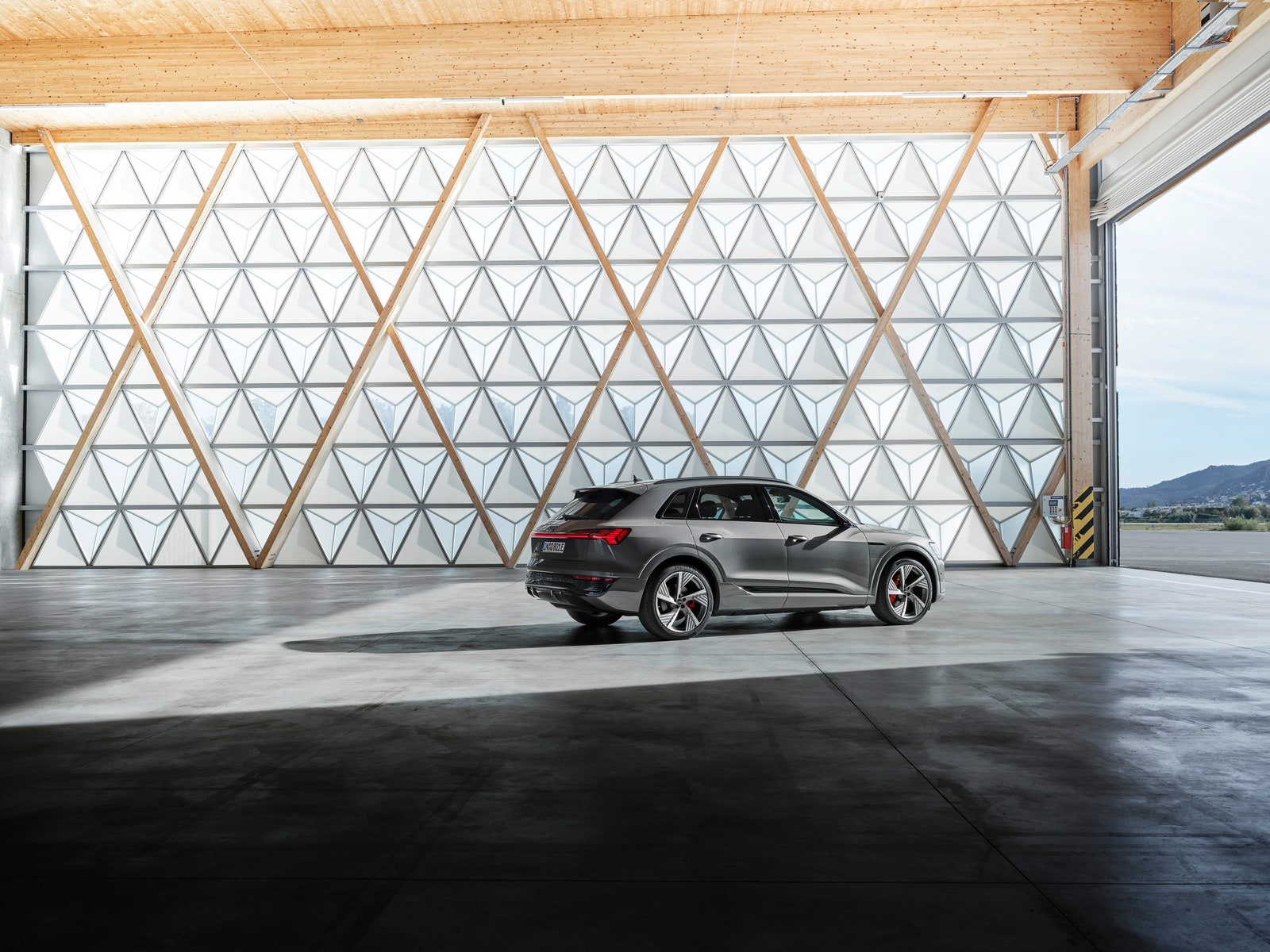 Audi Q8 Etron parked in a large modern garage