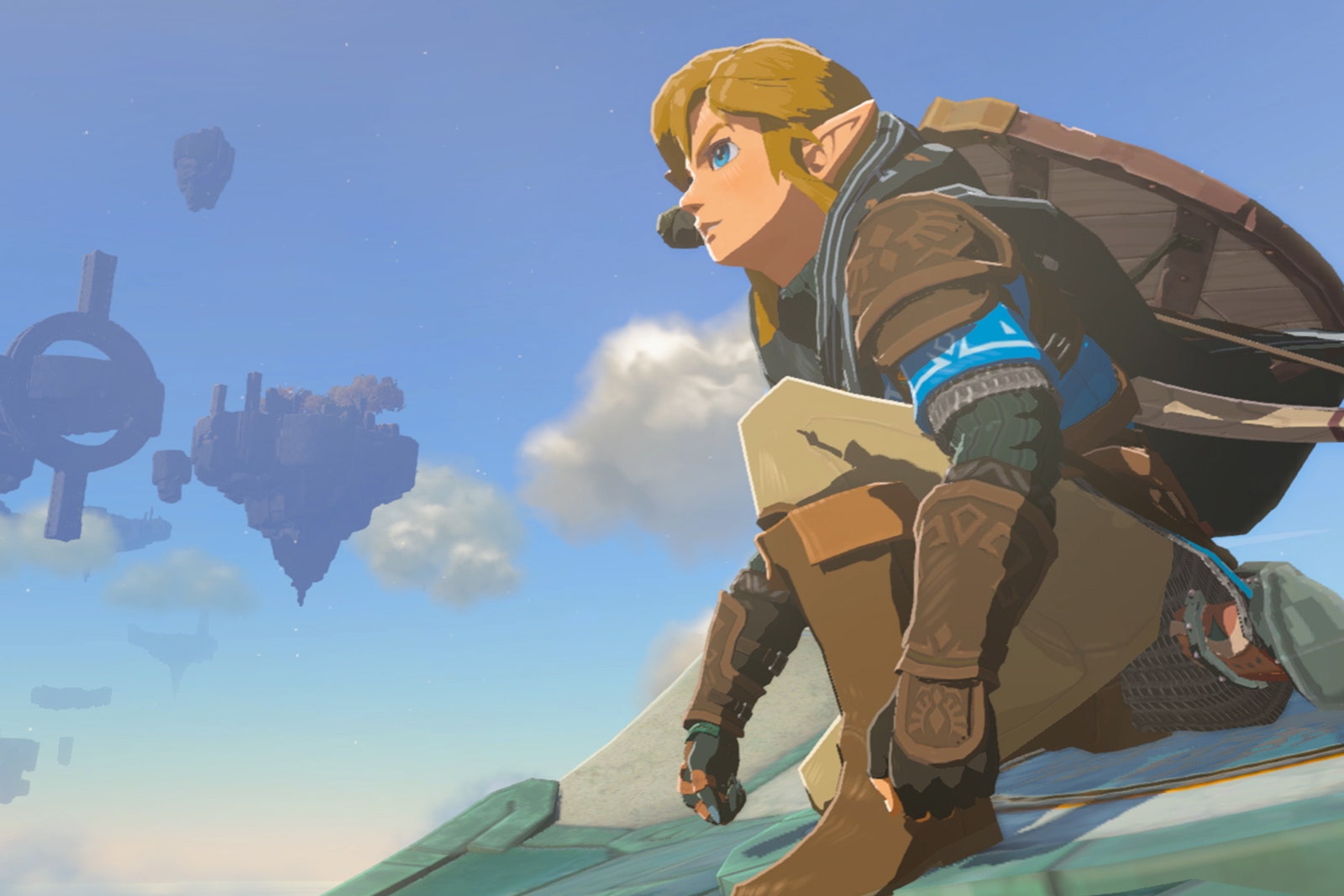 Screenshot from the game 'The Legend of Zelda Tears of the Kingdom' featuring Link kneeling on top of a cliff