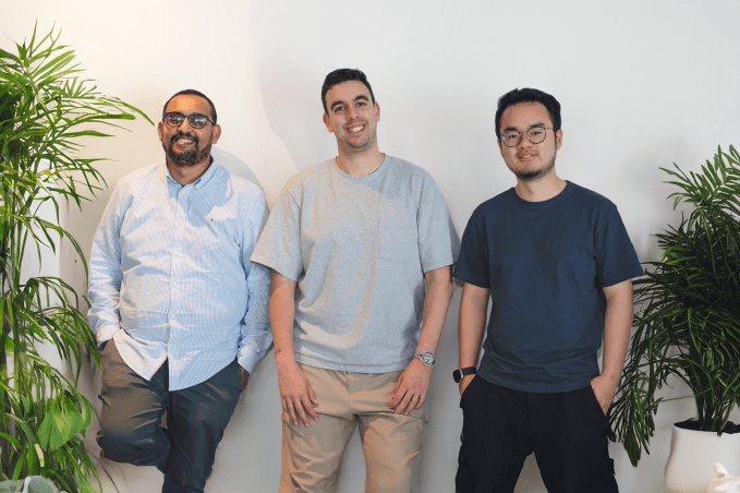 Heidi Health co-founders Waleed Mussa, Dr. Tom Kelly and Yu Lui pictured in front of a white wall with plants on the left and right of the photo