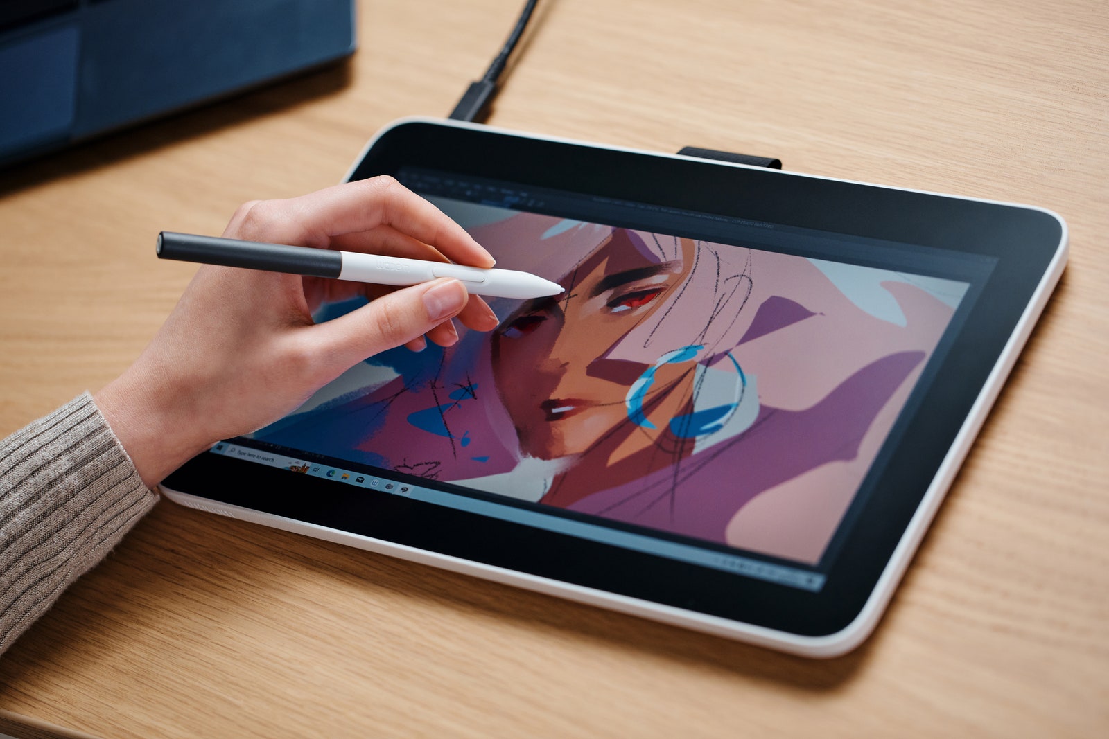 Closeup view of a person drawing on the Wacom One 13 tablet