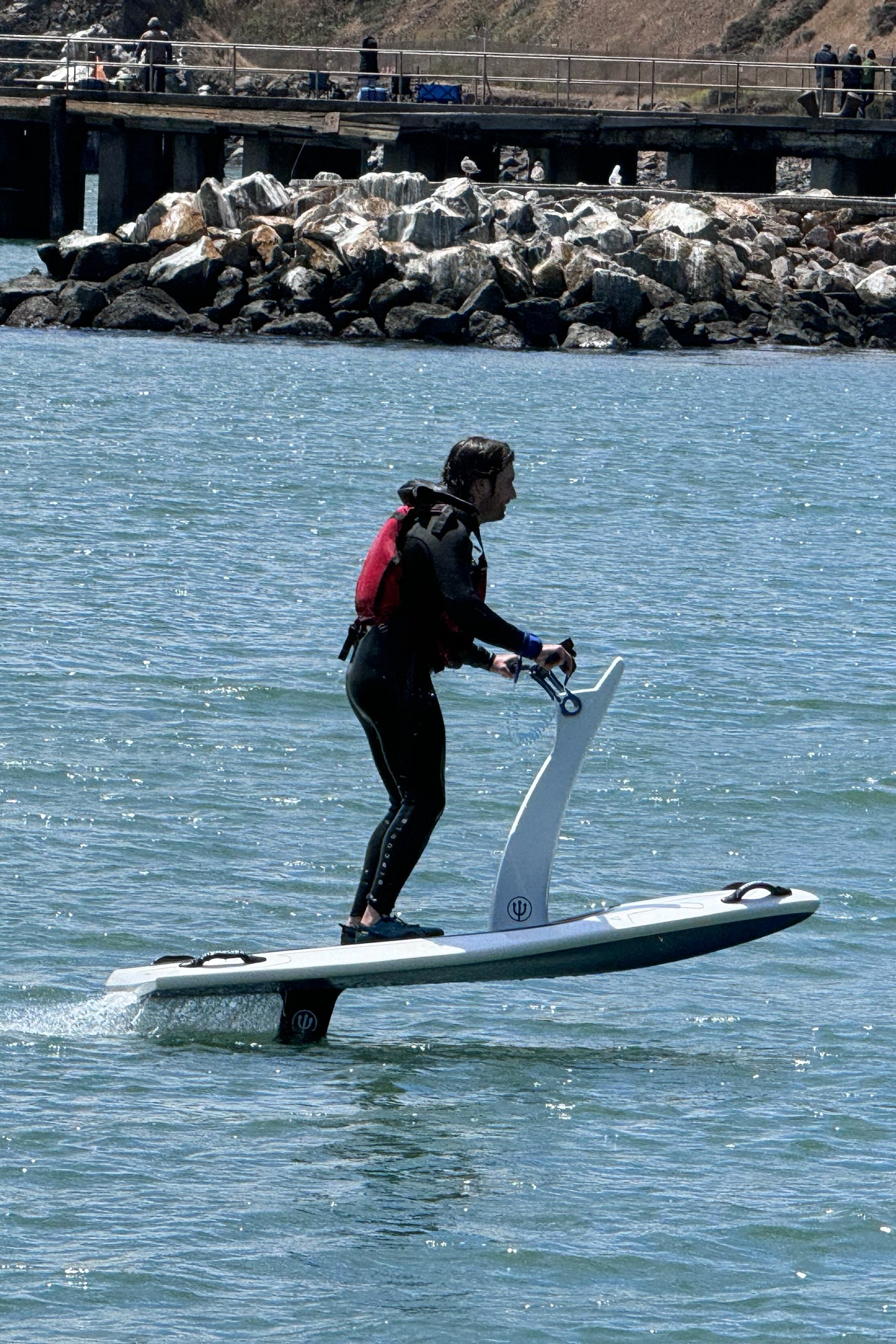 A photo of Boone Ashworth testing out the Hydrofoil in the waters of the bay in San Francisco CA.