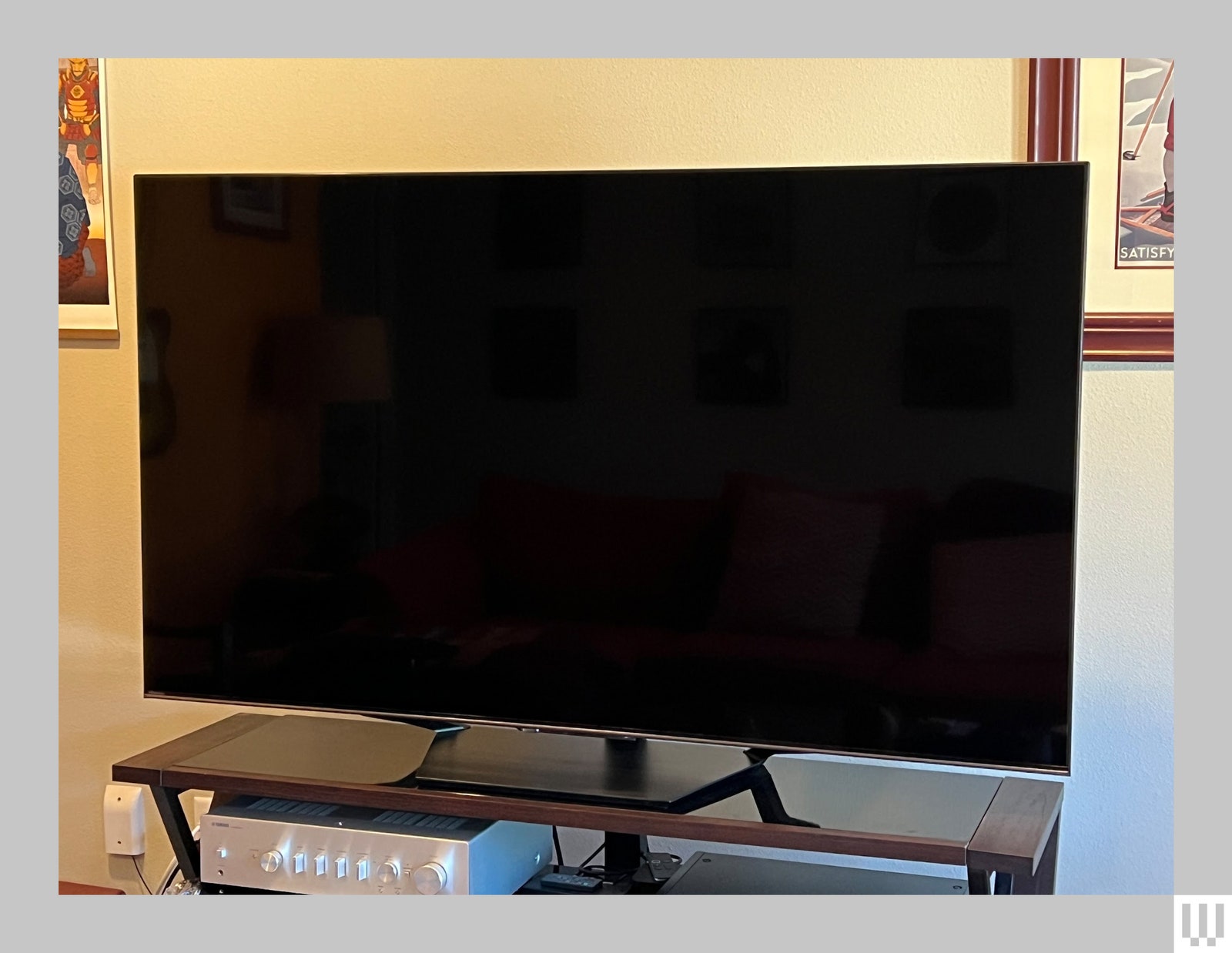 Front view of a large screen tv on a wooden media stand