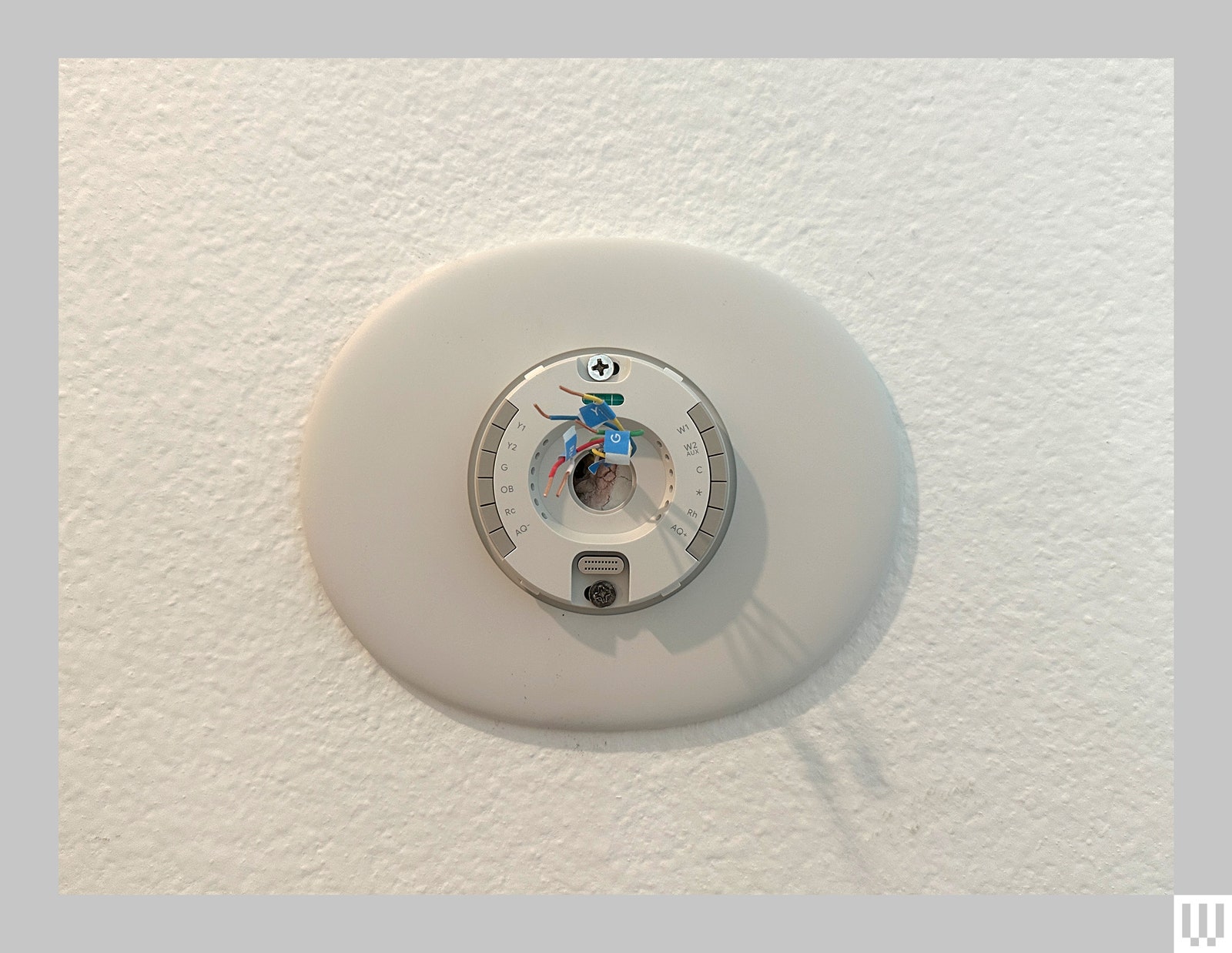 Circular outlet on a wall with wired sticking out