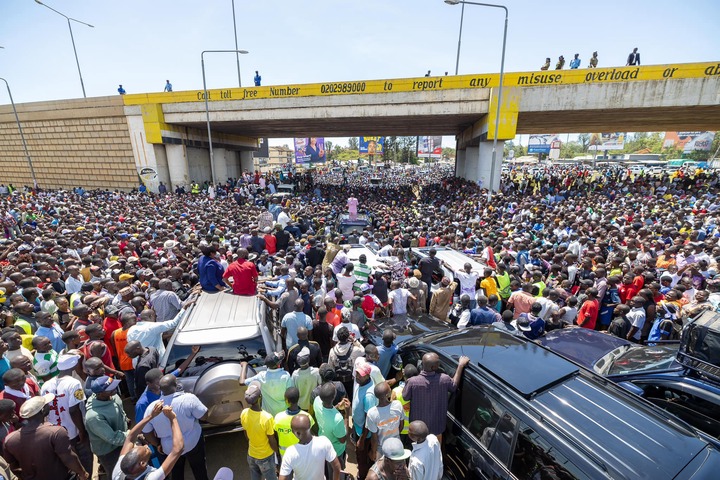 May be an image of 1 person, car, crowd and text