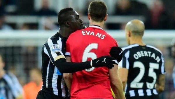 Papiss Cisse Appears to Spit at Jonny Evans During a Premier League Match at St. James Park. Image: Getty.