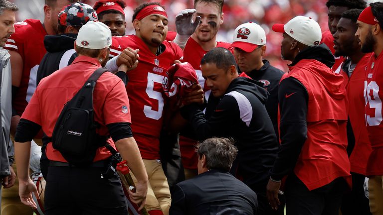 Lance is helped onto the cart by Niners staff 