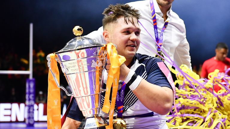 Tom Halliwell celebrates with the World Cup after guiding England to victory over France in the final