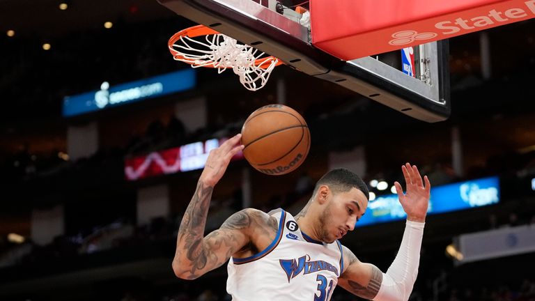 Washington Wizards&#39; Kyle Kuzma dunks the ball during the second half of an NBA basketball game against the Houston Rockets.