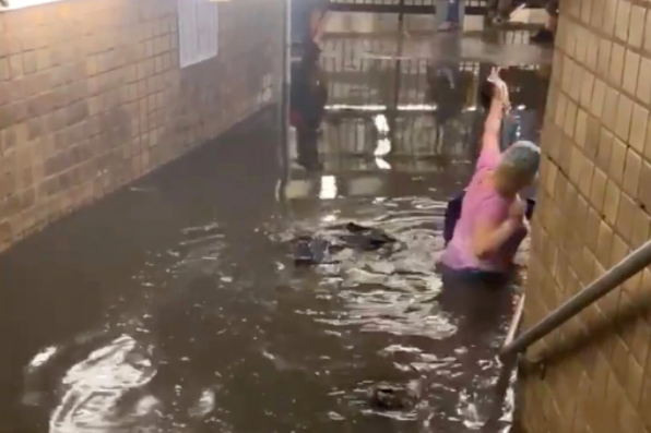 Commuters wade through dirty water as subway stations in New York flood following heavy rain (video)