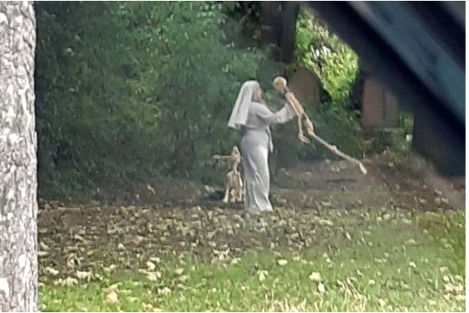 Woman dressed as nun seen dancing?with skeletons in graveyard