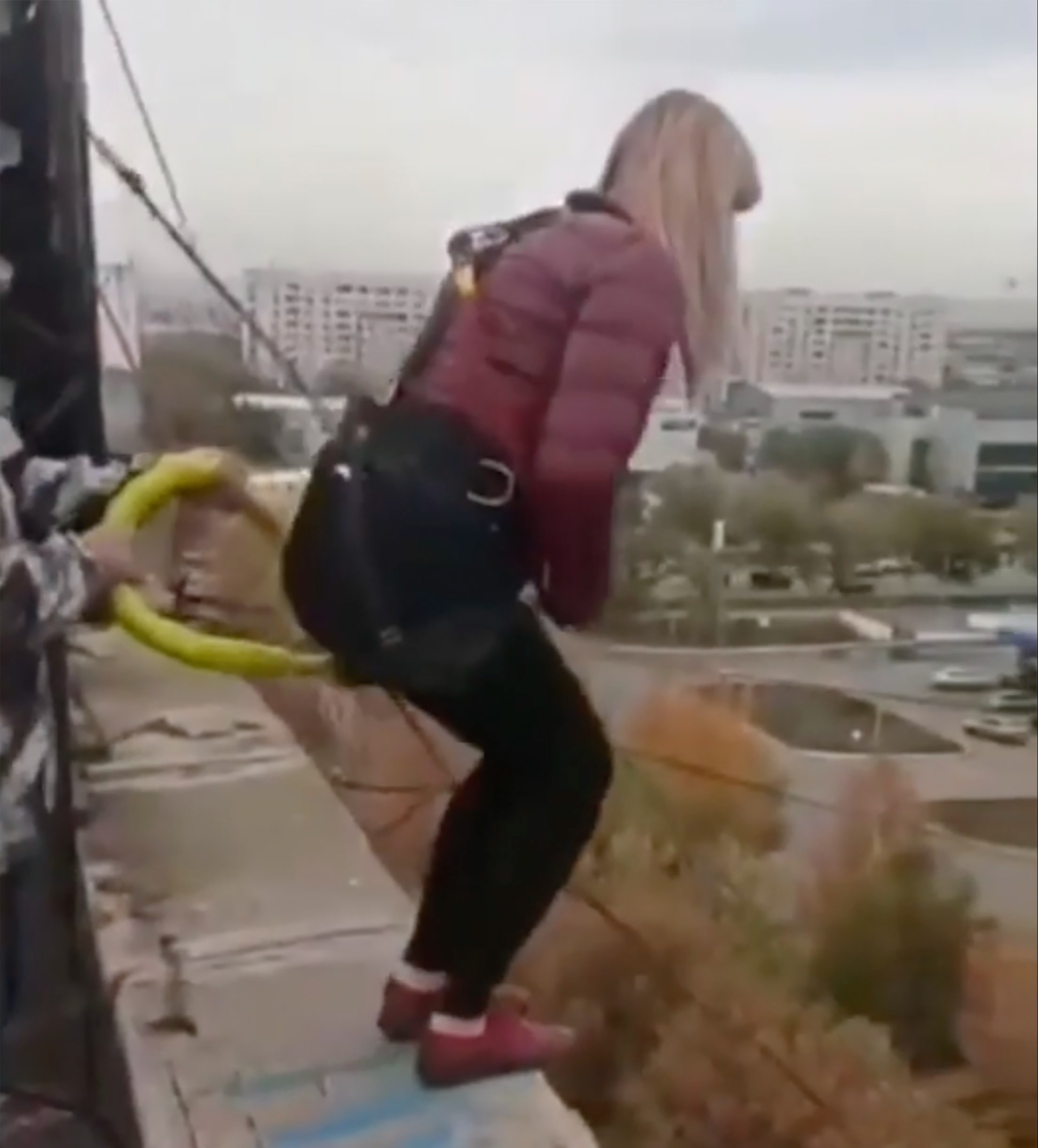 Yevgenia preparing for her leap off a rooftop of a Kazakhstan hotel