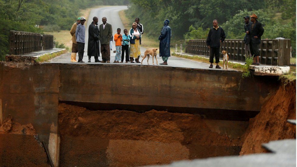 In Chimanimani, Zimbabwe, locals overlook an entire bridge that has been washed away.