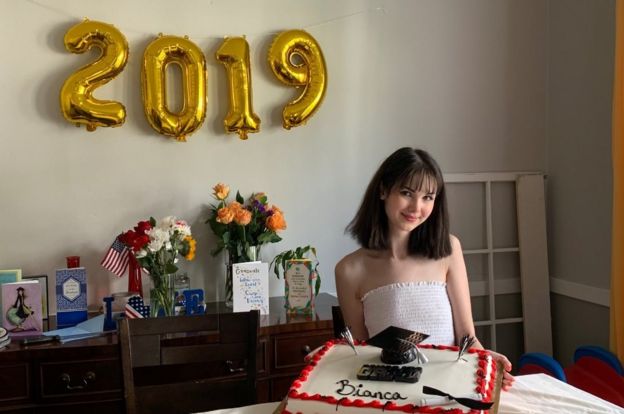 Bianca is seen amongst graduation gifts and next to 2019 balloons