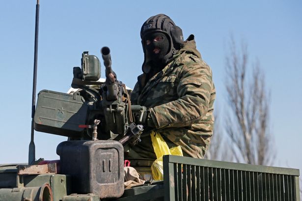 A service member of pro-Russian troops in a uniform without insignia is seen atop of an armoured vehicle during Ukraine-Russia conflict outside the separatist-controlled town of Volnovakha in the Donetsk region, Ukraine March 12, 2022. REUTERS/Alexander Ermochenko