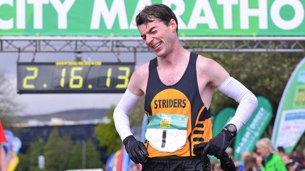 Paul Pollock shows the pain and the pleasure after his Belfast City Marathon win on Sunday