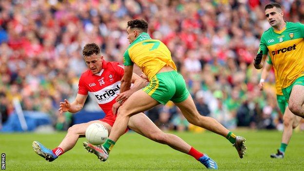 Derry's Shane McGuigan is challenged by Donegal's Odhran McFadden-Ferry