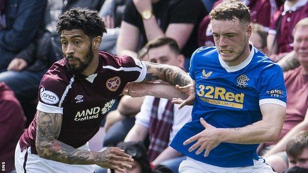 Hearts' Josh Ginnelly challenges Leon King of Rangers