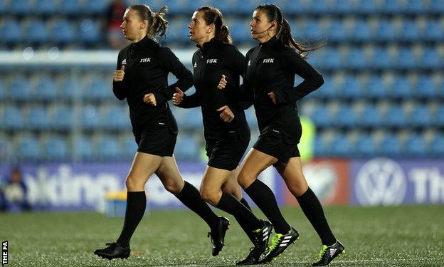 Assistant Svitlana Grushko, Referee Kateryna Monzul and assistant Maryna Striletska warm up prior to the match between Andorra and England