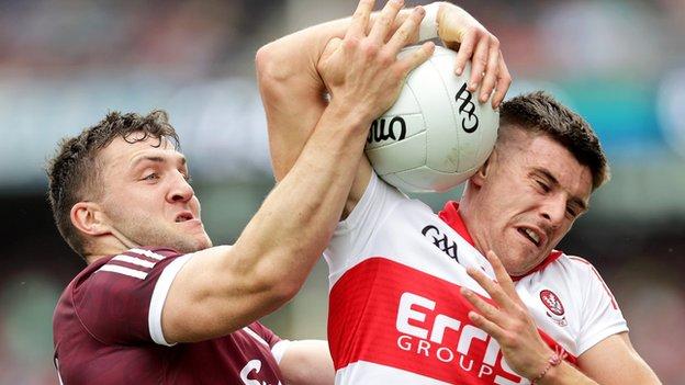 Derry's Conor Doherty attempts to get away from Galway's Damien Comer