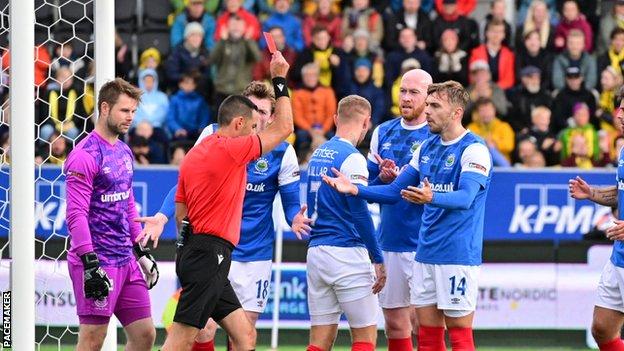 Kirk Millar receives a red card for handball