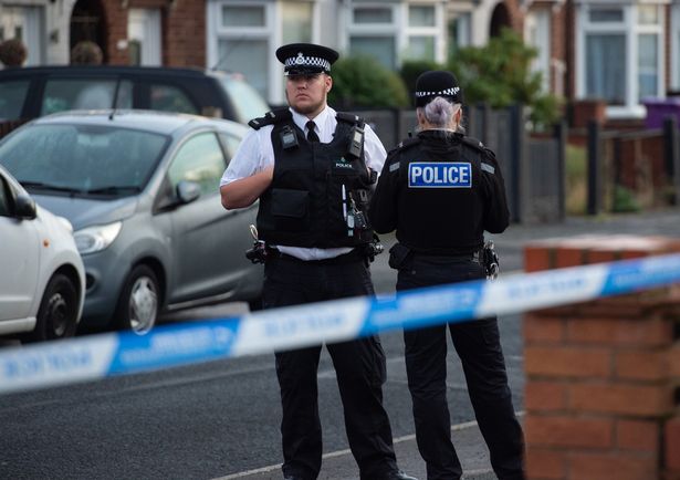 Police patrol the scene in Kingsheath Avenue