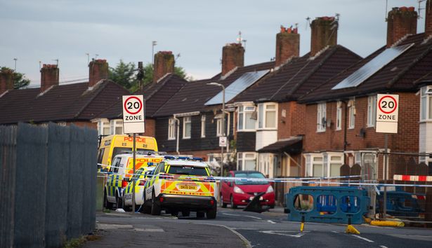 Police patrol the scene in Kingsheath Avenue