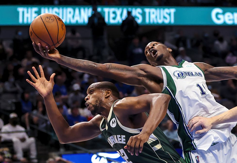 Dallas Mavericks forward Dorian Finney-Smith (10) grabs the ball over Milwaukee Bucks forward Khris Middleton (22) during the second half at American Airlines Center in Dallas, Texas.