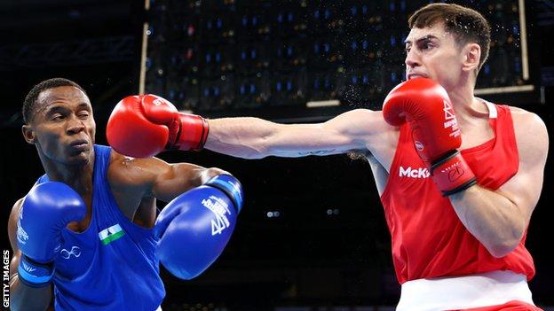 Aidan Walsh attempts to land a right hand on Lesotho's Arena Pakela