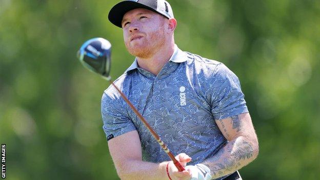 Canelo Alvarez takes a shot on the golf green