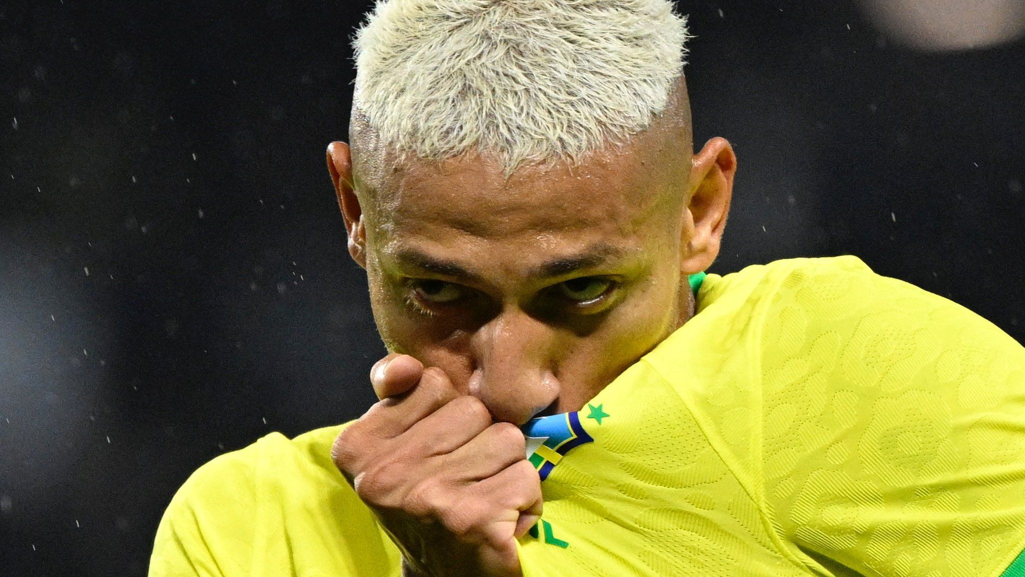 Richarlison kisses the Brazil badge