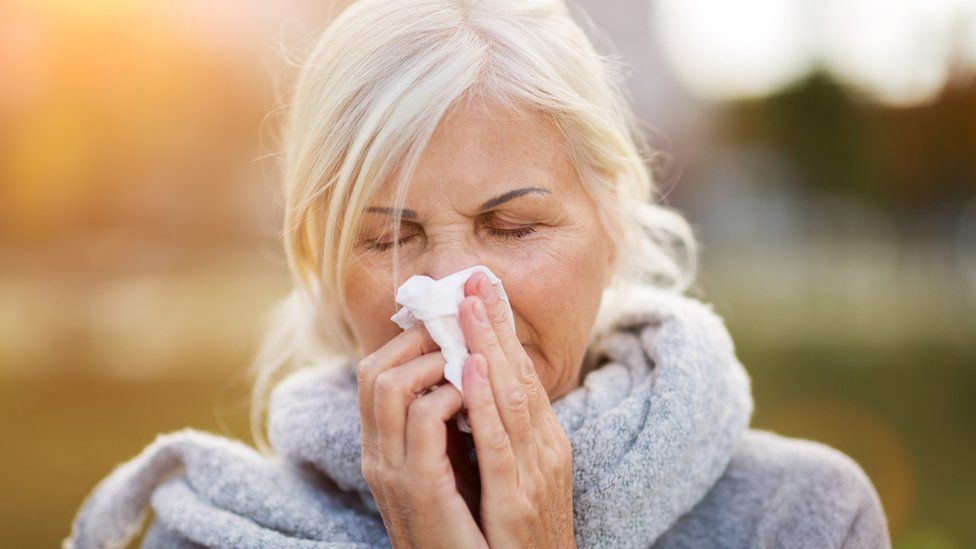 Woman using a tissue