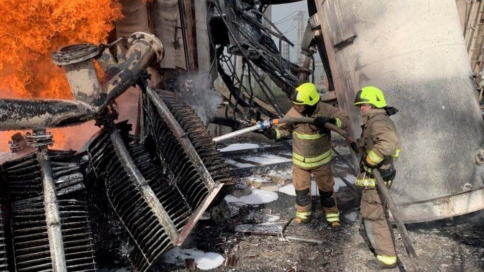 Firefighters tackle a blaze at an energy facility after a Russian attack in Rivne, western Ukraine. Photo: 22 October 2022