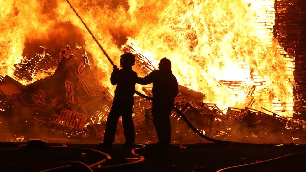 Firefighters extinguishing a huge bonfire in Cumbernauld