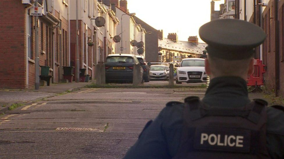 A police officer stands at a cordon at Dundela Street, where Kieran Smithson and the pipe bomb were found