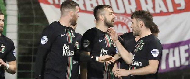 Glentoran players congratulate goalscorer Conor McMenamin