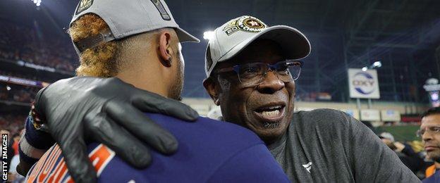 Houston Astros manager Dusty Baker is hugged by catcher Martin Maldonado