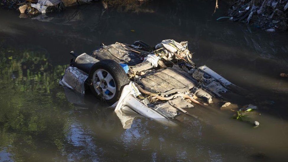 View of a car dragged by the current in the Los Ríos neighbourhood flooded by the rains, in Santo Domingo, Dominican Republic, 05 November 2022.