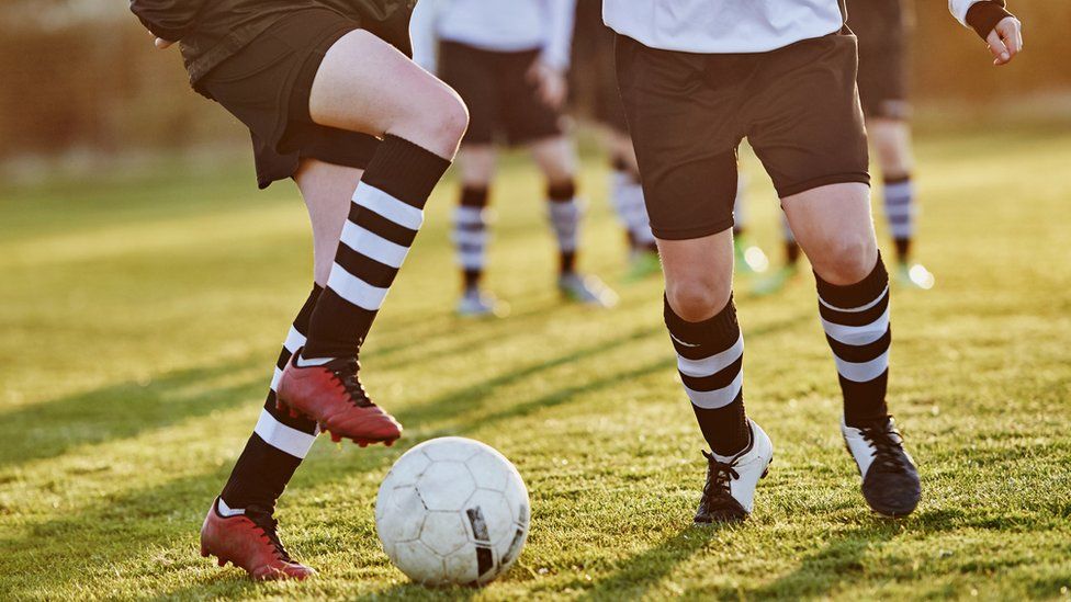 Women footballers wearing black shorts