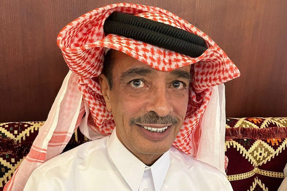 Naji Rashed Al Naimi, a Qatari man, is pictured sitting on a sofa and wearing a traditional kaffiyeh headdress