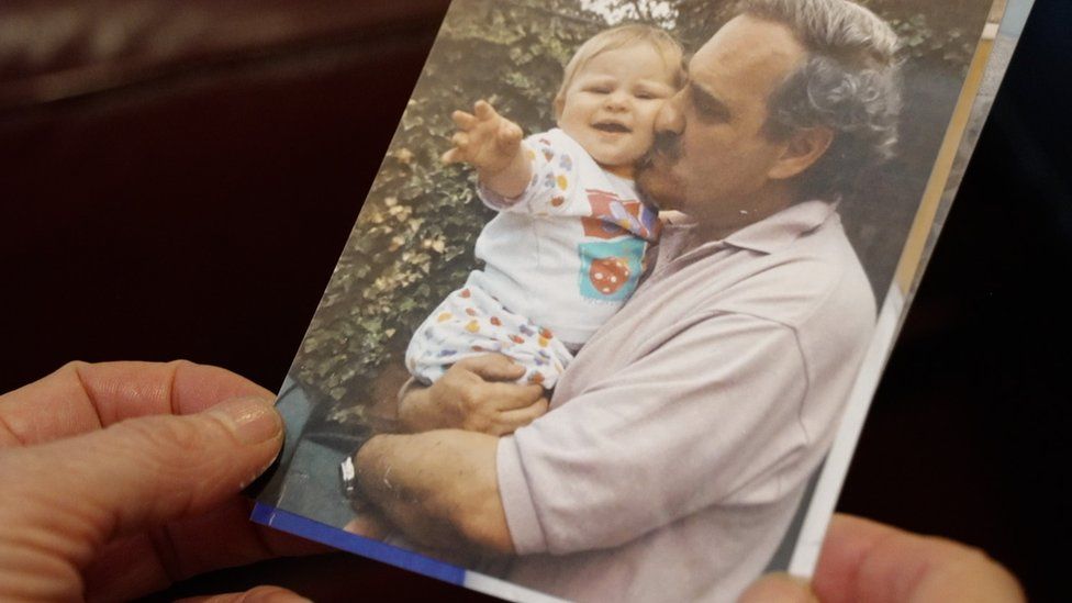 A photo of Michael Woodward kissing his granddaughter