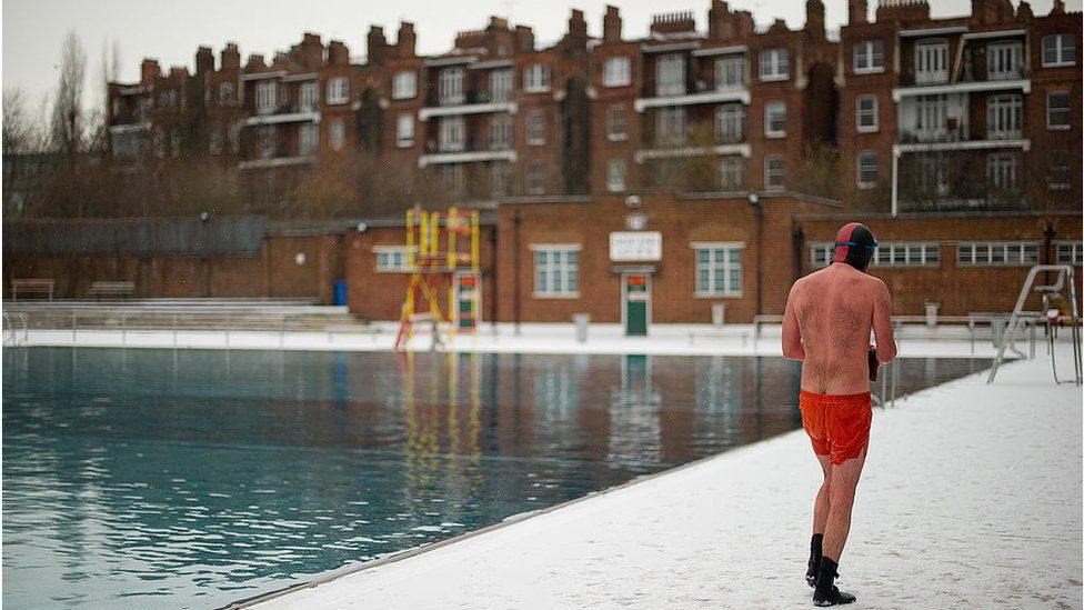 Man walking away from pool at Parliament Hill Lido