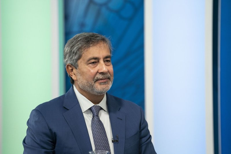 Sanjay Mehrota, President and CEO at Micron, listens during a meeting with President Joe Biden, at the Eisenhower Executive Office Building on March 9. He announced possible layoffs on Wednesday. File Photo by Sarah Silbiger/UPI | <a href="/News_Photos/lp/0c75e2771242933b66ed280ee426853e/" target="_blank">License Photo</a>