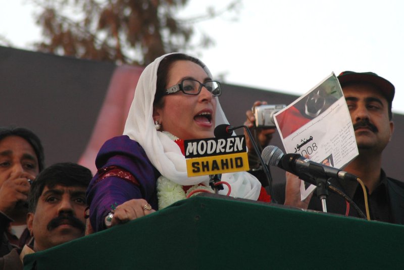 Pakistan's former prime minister and opposition leader, Benazir Bhutto, speaks with the watchful eye of security during an election rally in Rawalpindi on December 27, 2007. Bhutto was assassinated shortly thereafter when she left the election rally. UPI File Photo | <a href="/News_Photos/lp/bf954d47b51506dce2fc1493db4be567/" target="_blank">License Photo</a>