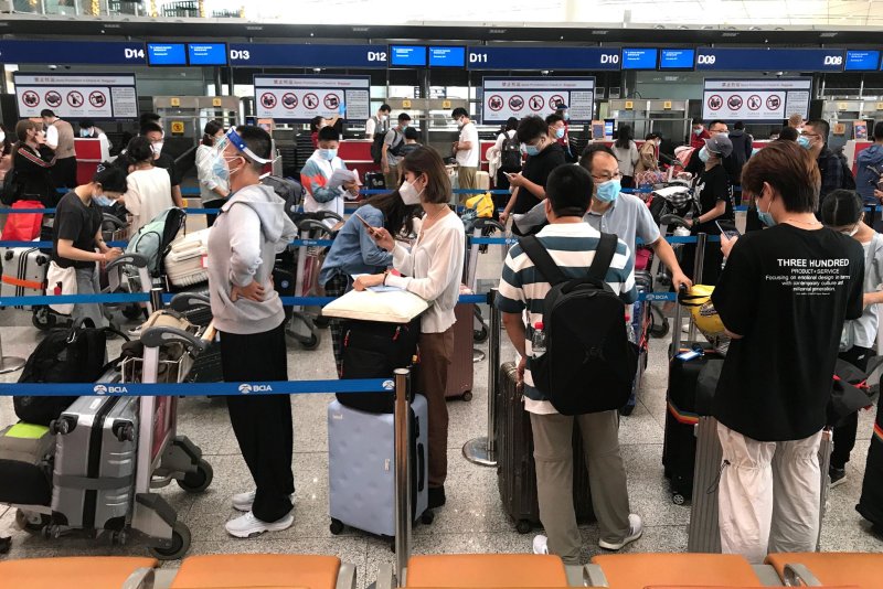 Passengers wait to check in for their flights at Beijing international airport on Wednesday, August 18, 2021. The United States and other nations plan to introduce new restrictions as China loosens its travel restrictions amid a new wave of COVID-19 infections. File Photo by Stephen Shaver/UPI | <a href="/News_Photos/lp/fd461761b53c67a8250160f5e35c8ca3/" target="_blank">License Photo</a>